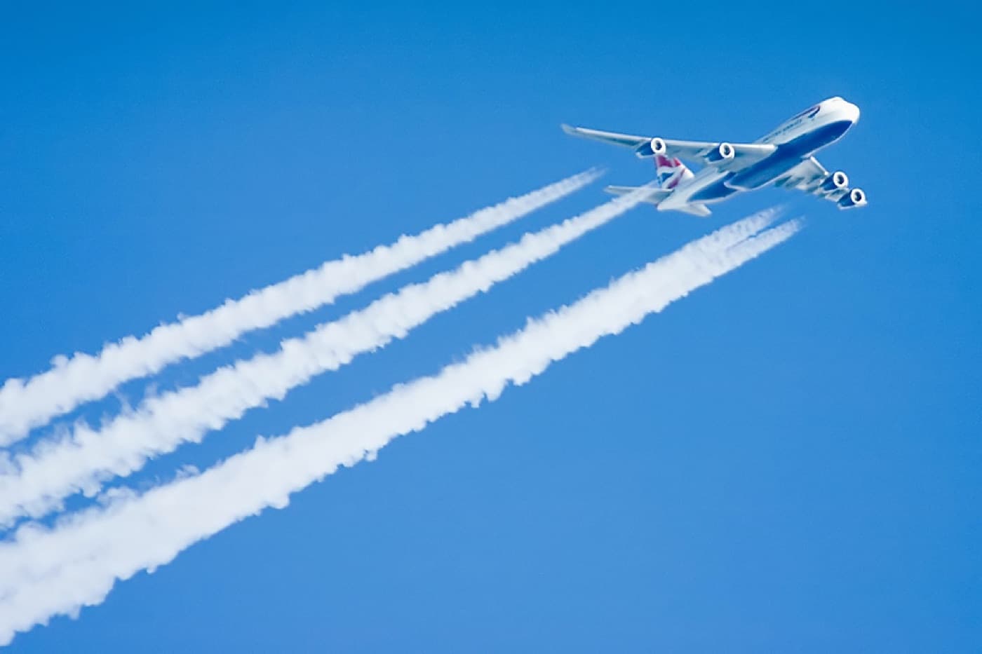 Commercial aircraft in flight with visible engine contrails