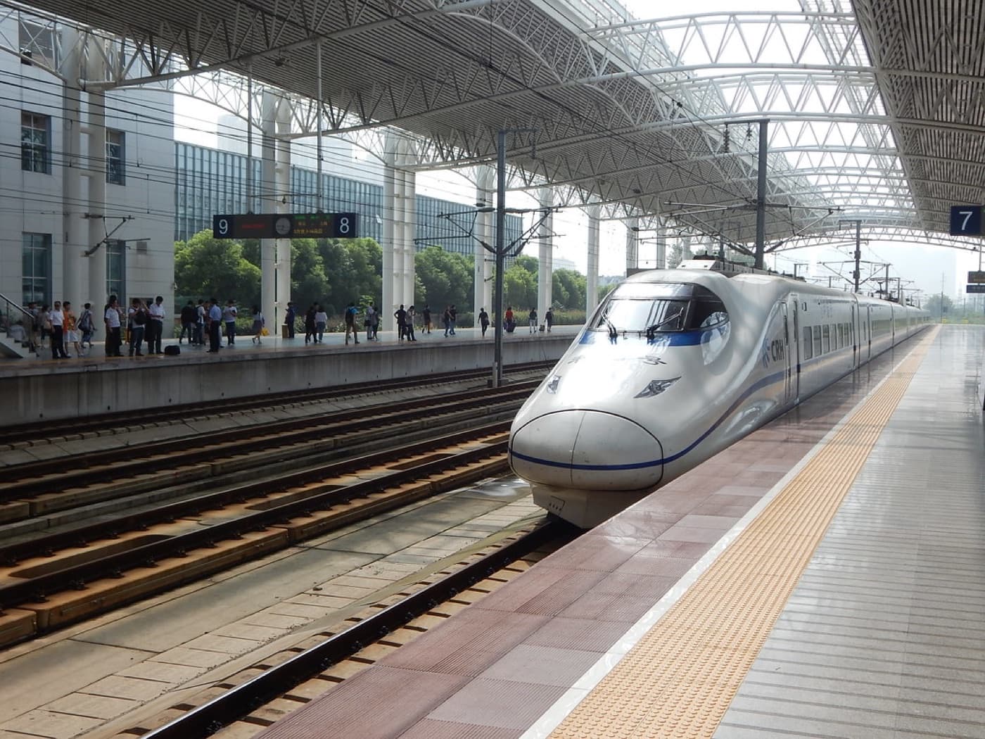 High-speed train arriving at a station platform