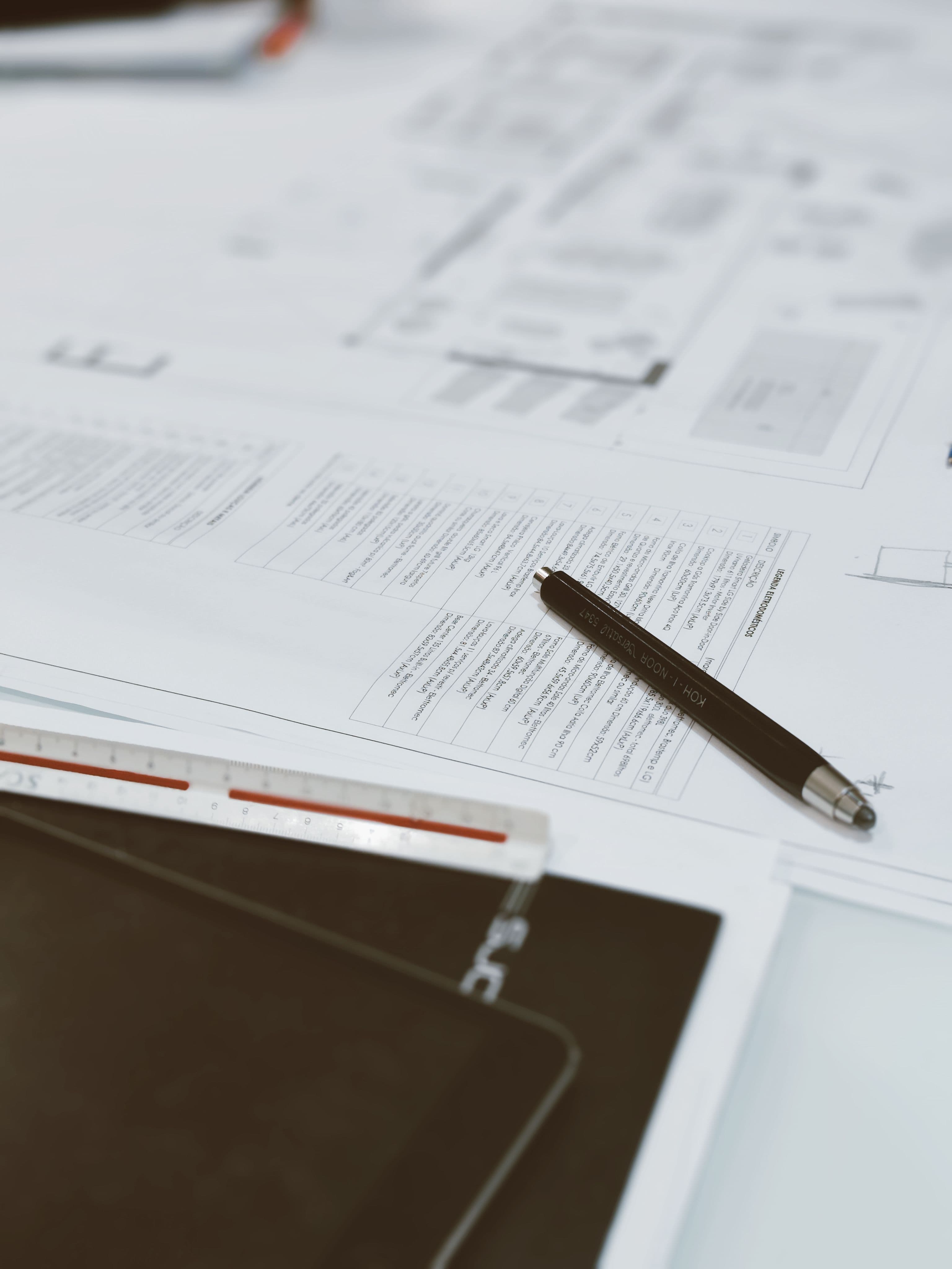 Blueprints and drafting tools on a designer's desk