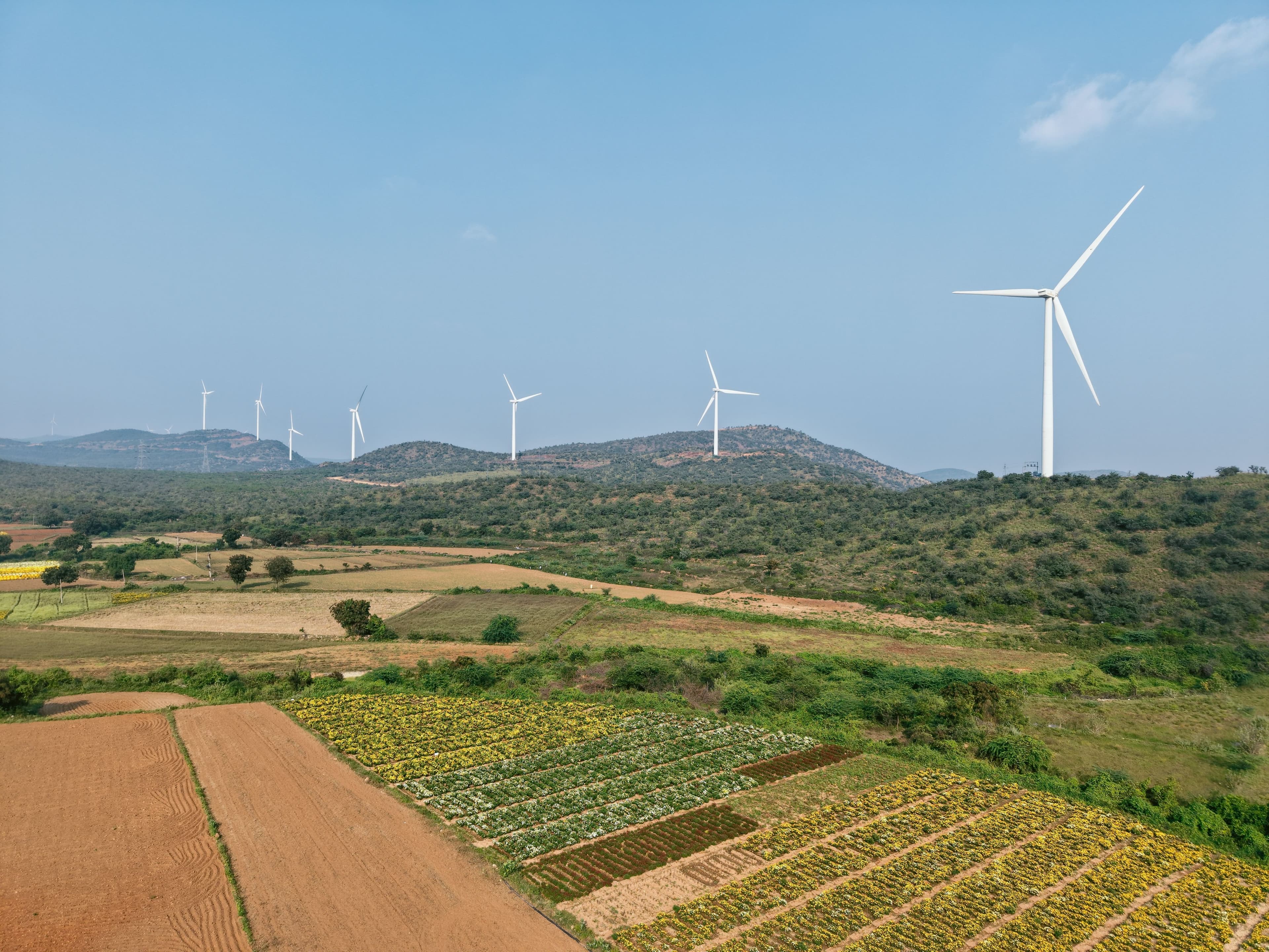 Aerial view of wind turbines across a rural landscape